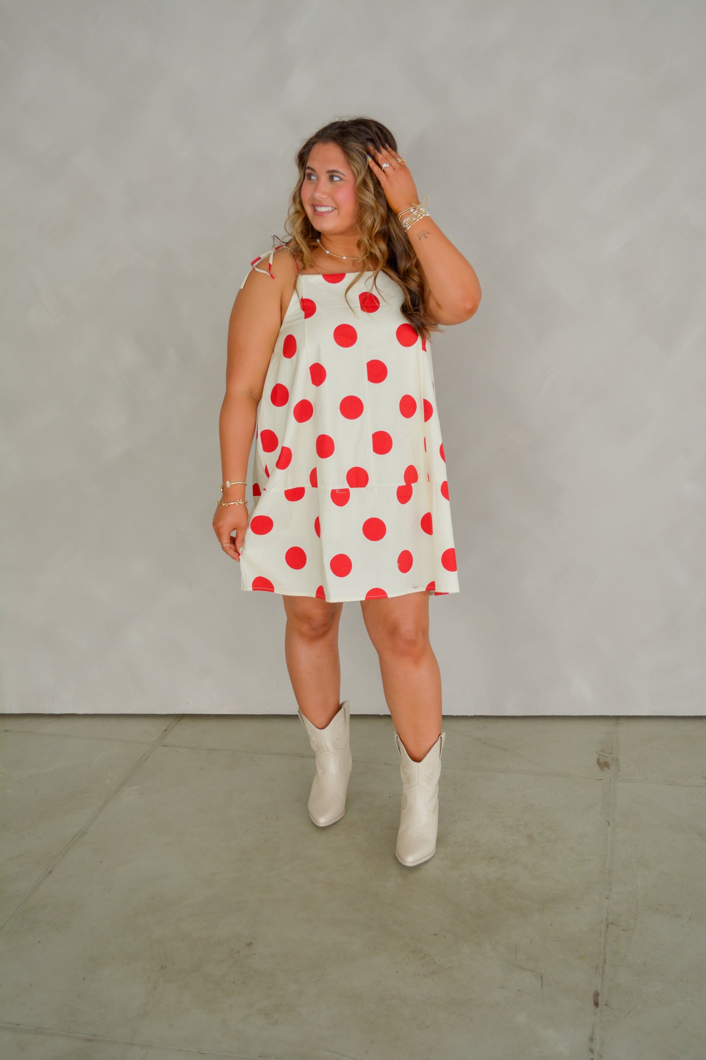 Red Retro Romance Dress by Peach Love California displayed on a hanger, showcasing its vintage-inspired design and vibrant color.