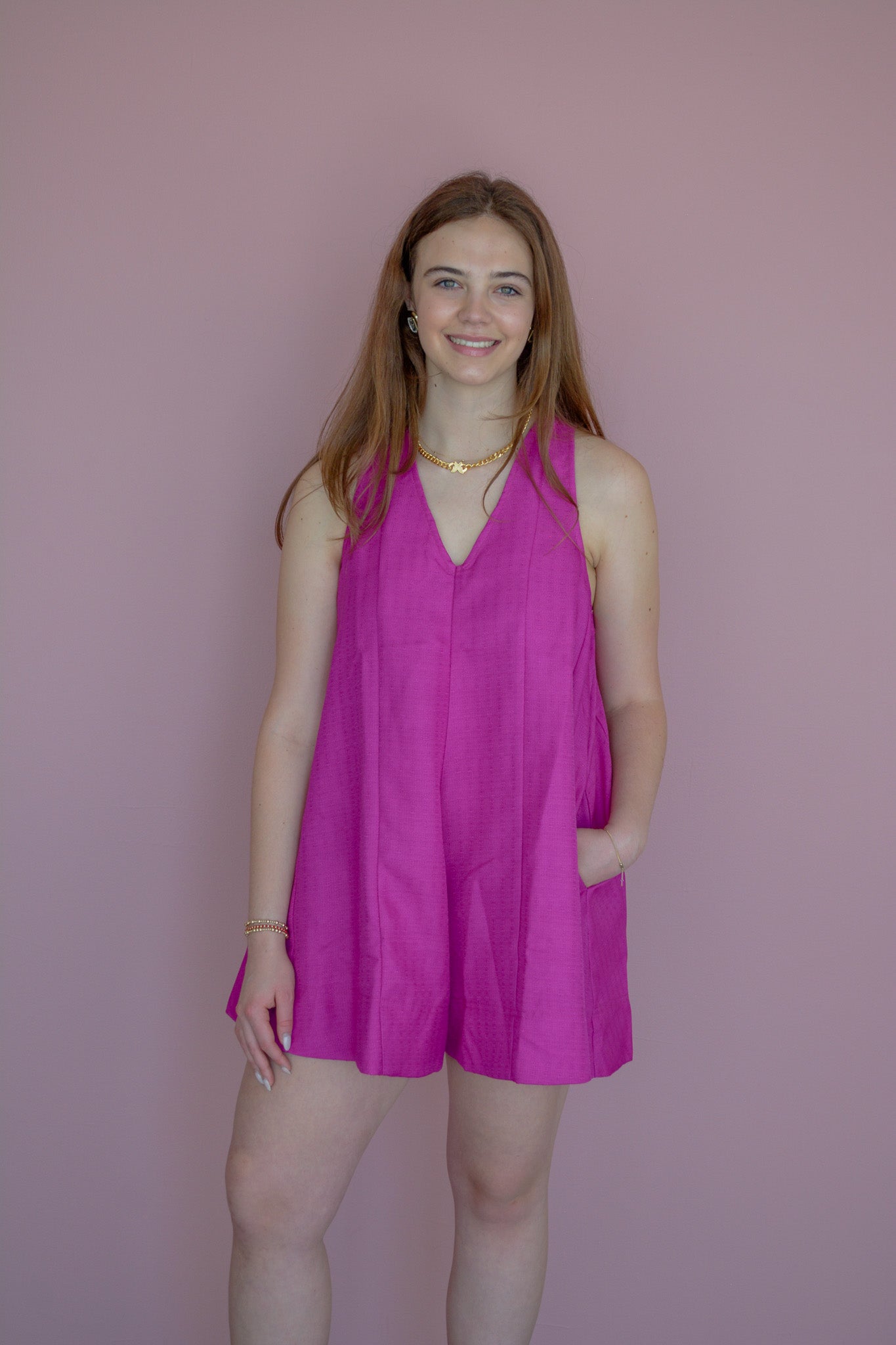 GLAM Flirt & Flow romper displayed on a hanger, featuring a stylish, lightweight design with a V-neck and short sleeves.