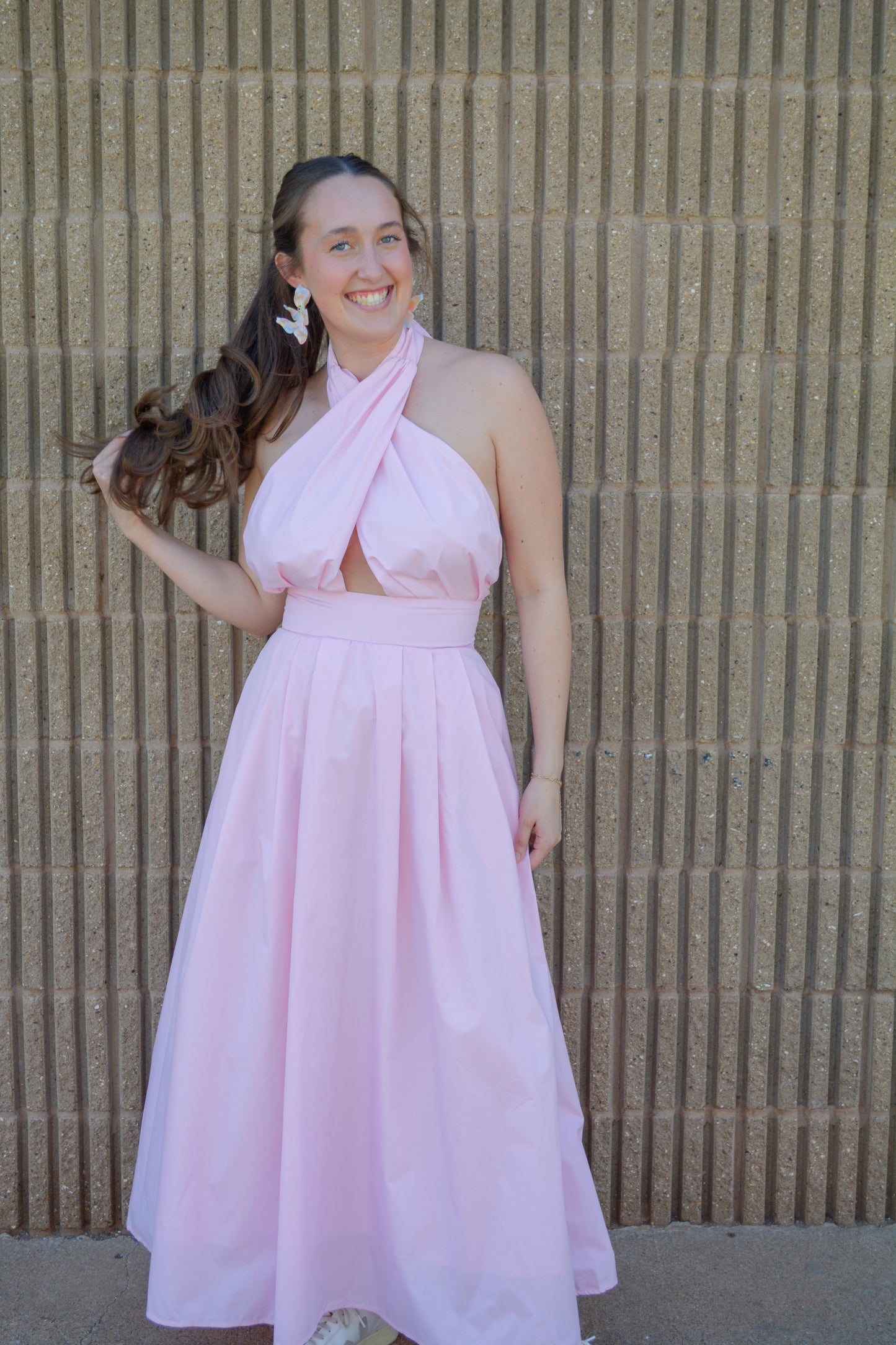Baby Pink Everlasting Spring Maxi Dress displayed on a hanger with floral patterns and flowing fabric for a stylish summer look.