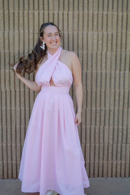 Baby Pink Everlasting Spring Maxi Dress displayed on a hanger with floral patterns and flowing fabric for a stylish summer look.