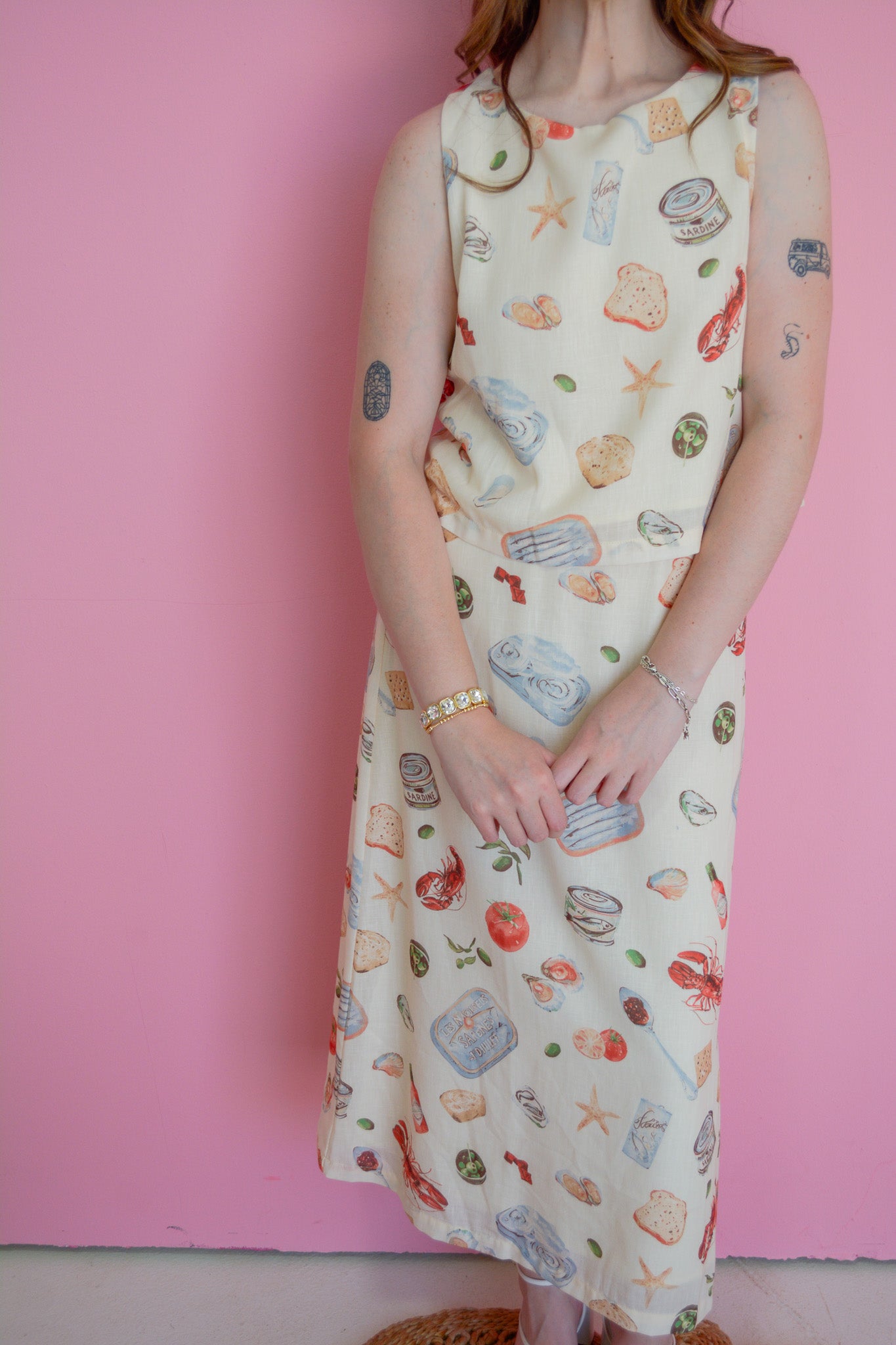 Able Seaside Pantry Tank Top displayed on a hanger, featuring a casual sleeveless design with a light, airy fabric for summer wear.