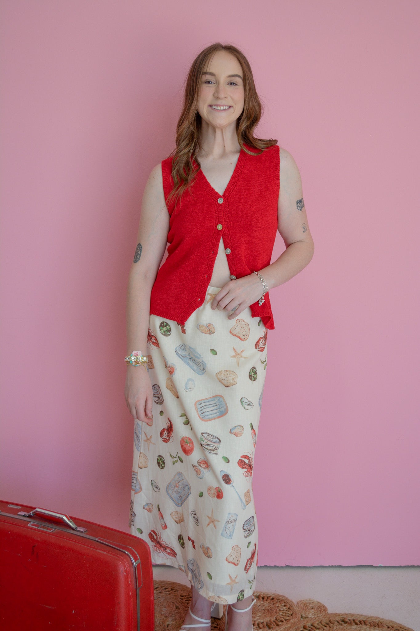 Able Seaside Pantry midi skirt in lightweight fabric with a flowy silhouette and floral pattern, displayed on a hanger.