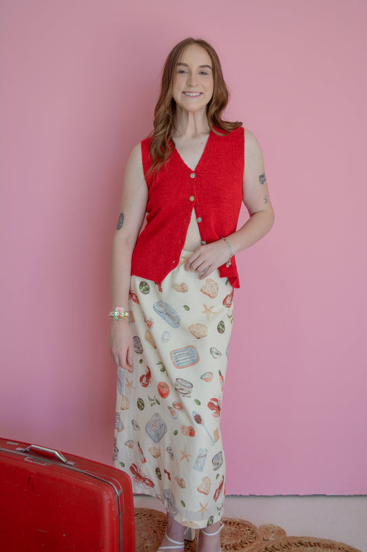 Able Seaside Pantry midi skirt in lightweight fabric with a flowy silhouette and floral pattern, displayed on a hanger.