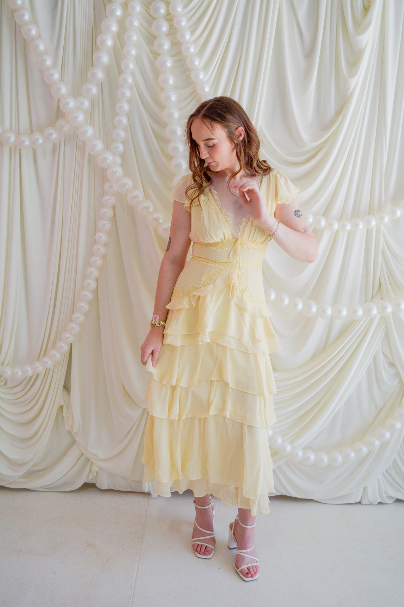 Storia Sunshine Bliss Midi Dress displayed on a hanger with floral print and flowing fabric, perfect for summer or casual wear.