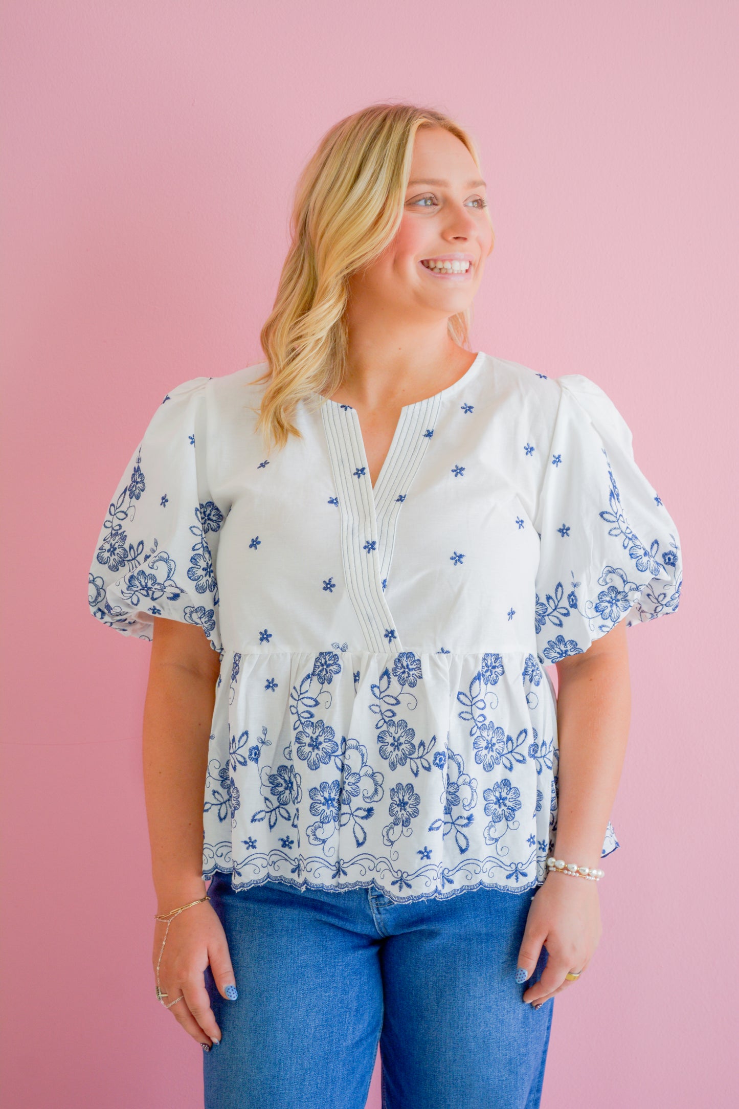 She+Sky Midnight Floral Blouse displayed on a hanger with a dark floral pattern and lightweight fabric.