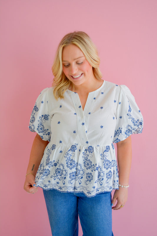 She+Sky Midnight Floral Blouse featuring a dark floral print, long sleeves, and a relaxed fit, displayed on a hanger.