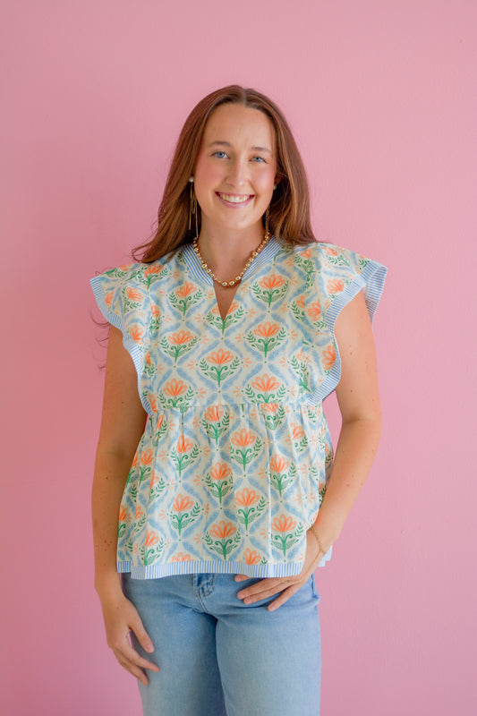 She+Sky Petal Pop Blouse shown on a hanger with floral petal design and lightweight fabric, ideal for casual or office wear.