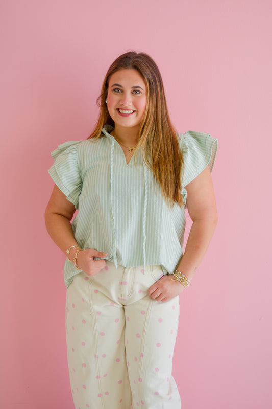 She+Sky Elegant Ease Tie Blouse with long sleeves and a relaxed fit, shown in a neutral color on a hanger.