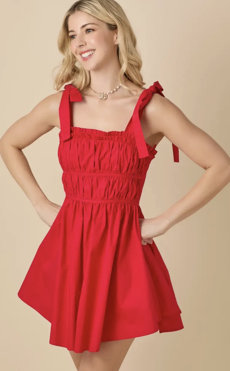 Baby Pink red ruched mini dress shown on a model, featuring a fitted silhouette and stylish ruffled details for a trendy look.