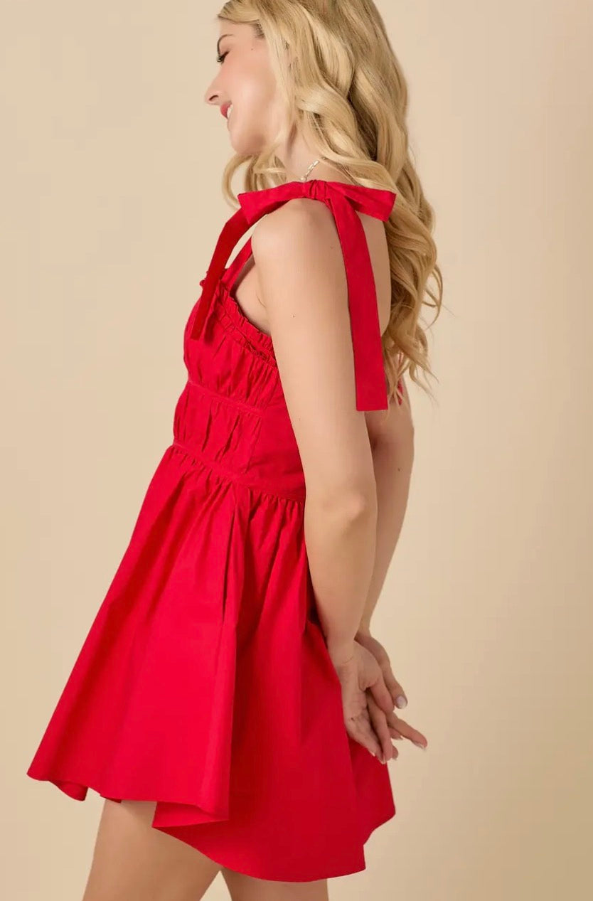 Baby Pink red ruched mini dress shown on a model, featuring a fitted silhouette and stylish ruching details.