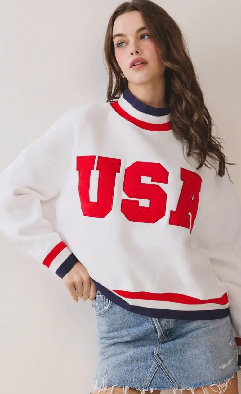 Men's navy blue The All-American Pullover by TCEC, shown on a hanger with a close-up of the fabric and design details.