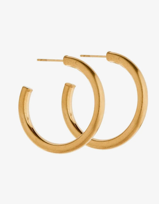Avery Gold Hoop Earrings by Linny CO, large shiny gold hoops with smooth finish, displayed on a plain background.