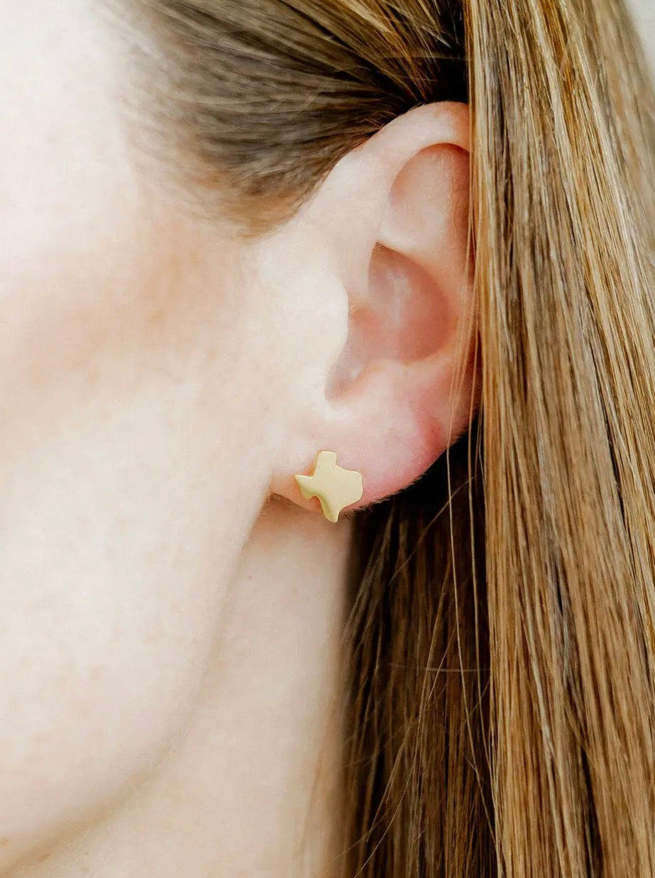 Linny CO Big Texas Gold screwback earrings with bold, gold-tone design and intricate detailing on a white background.