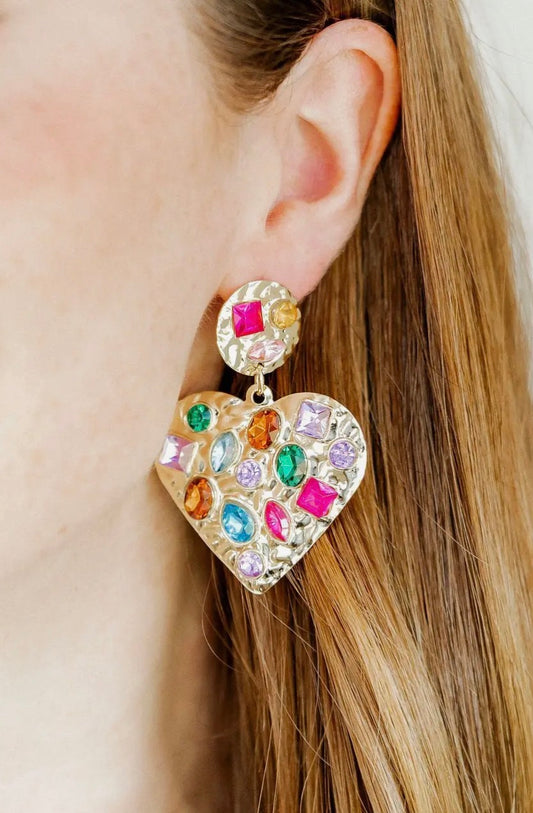 Linny CO Cherie Heart statement earrings featuring bold, gold heart-shaped dangles on a white background.