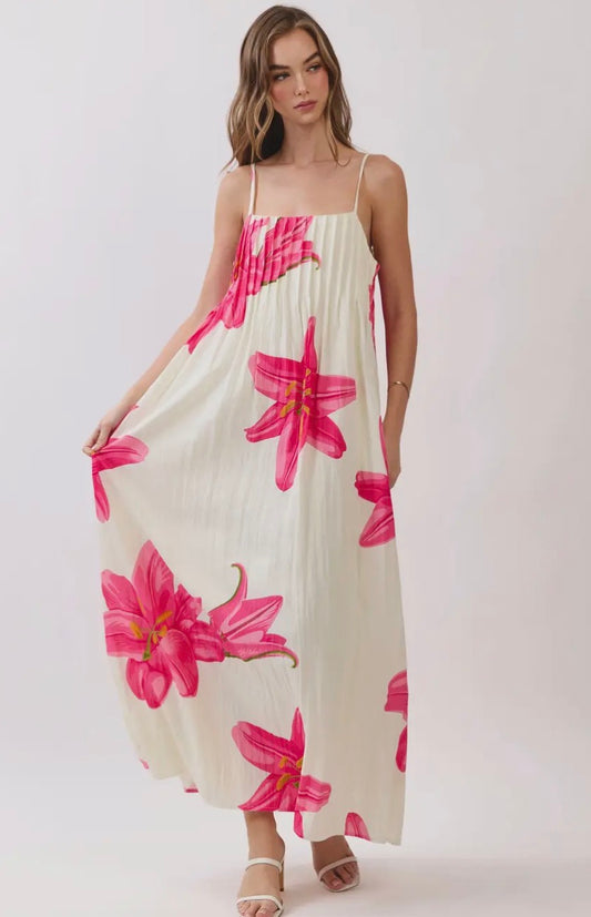 TCEC Tropical Petals Dress displayed on a mannequin with vibrant floral pattern and flowing fabric.