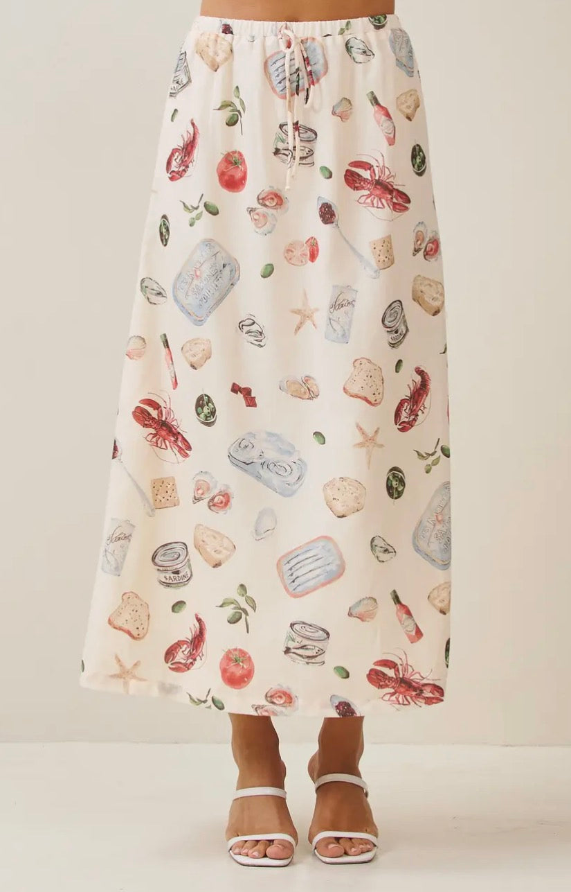 Able Seaside Pantry midi skirt in soft fabric, featuring a flowy silhouette and subtle pattern, styled for casual wear.