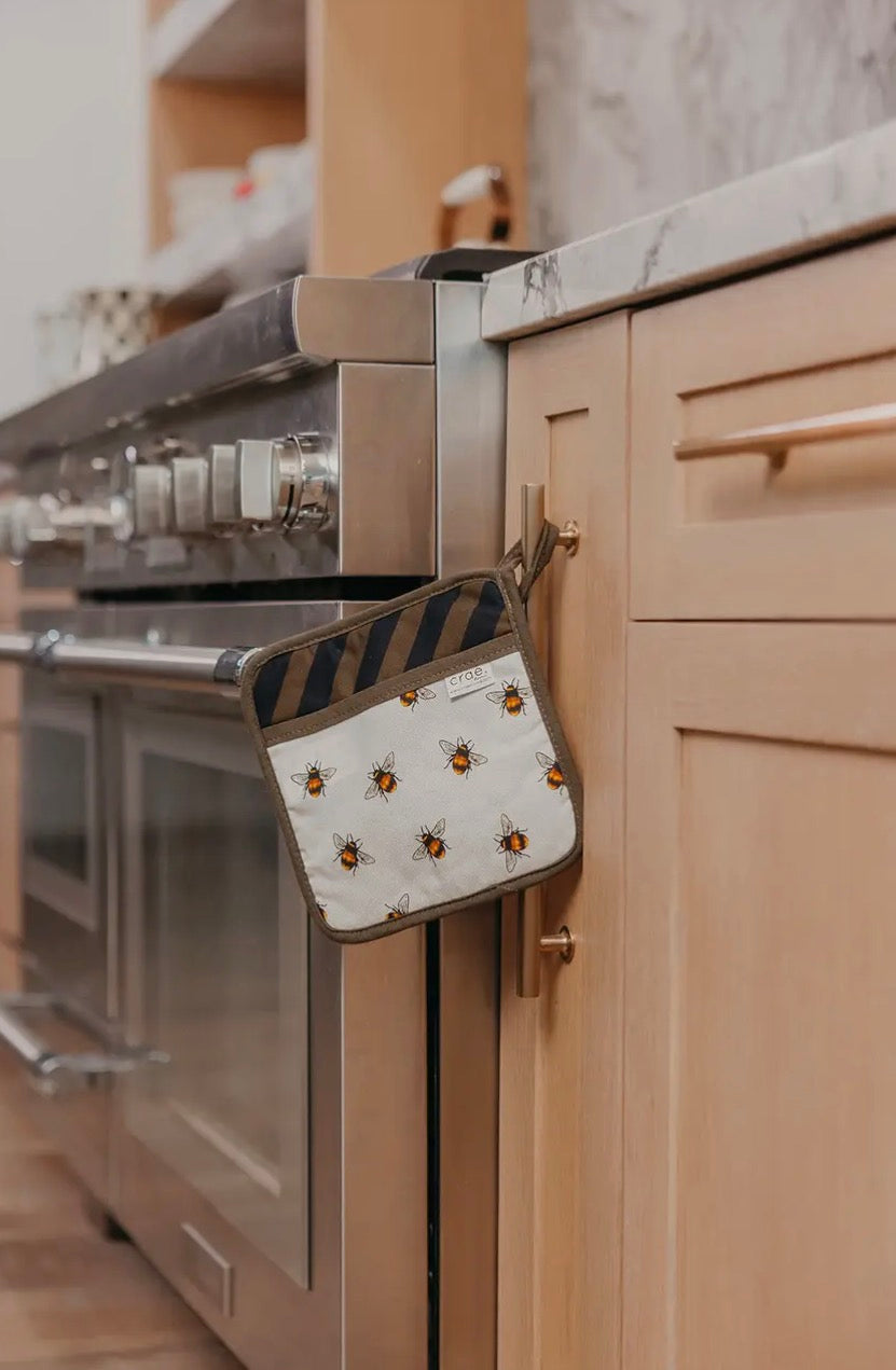 Crae.home pot pads set with colorful, heat-resistant fabric and cork backing, ideal for protecting surfaces from hot cookware.