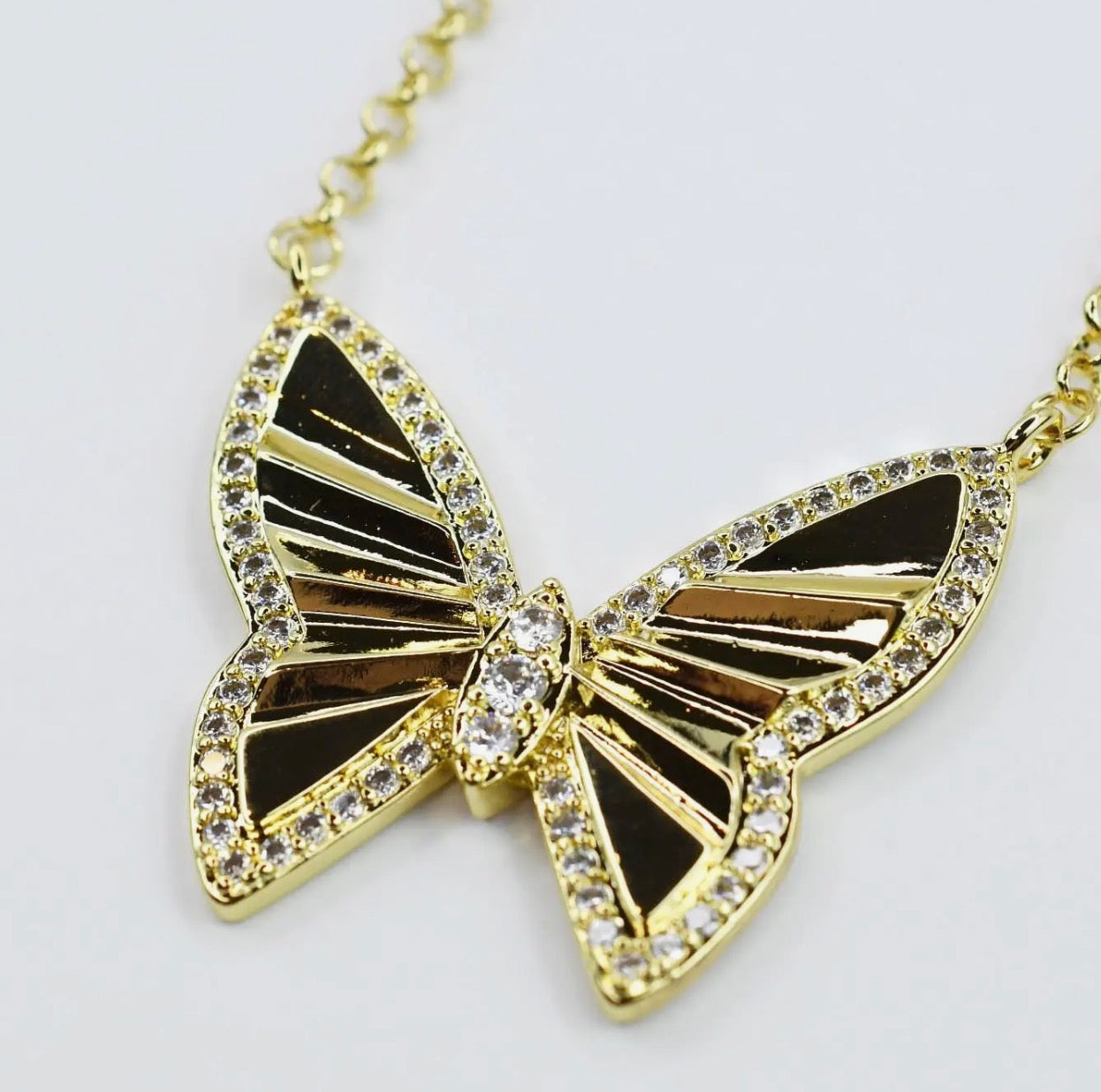 Treasure Jewels Radiant Flight Necklace featuring a delicate chain and sparkling gemstone pendant on a white background.