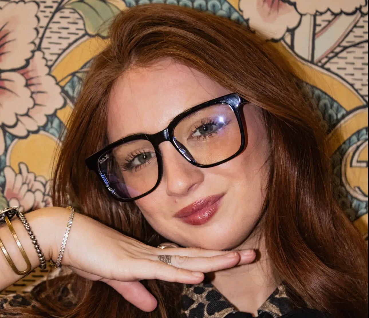 Dax Eyewear blue light glasses with clear frames and blue-tinted lenses for digital screen protection.
