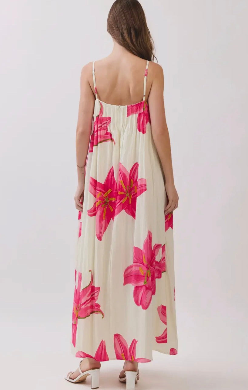 TCEC Tropical Petals dress displayed on a model, featuring vibrant floral patterns and a flowing, summery design.