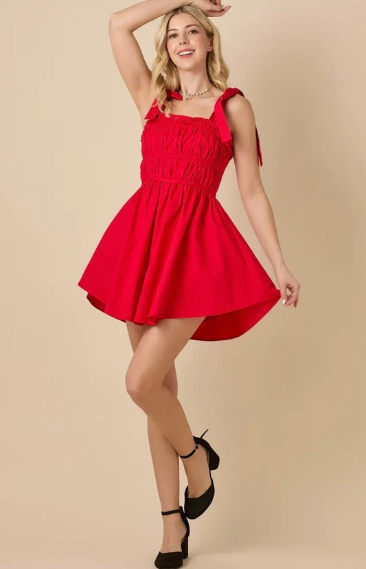 Baby Pink red ruched mini dress shown full-length, featuring fitted design, sleeveless style, and stylish ruching details.