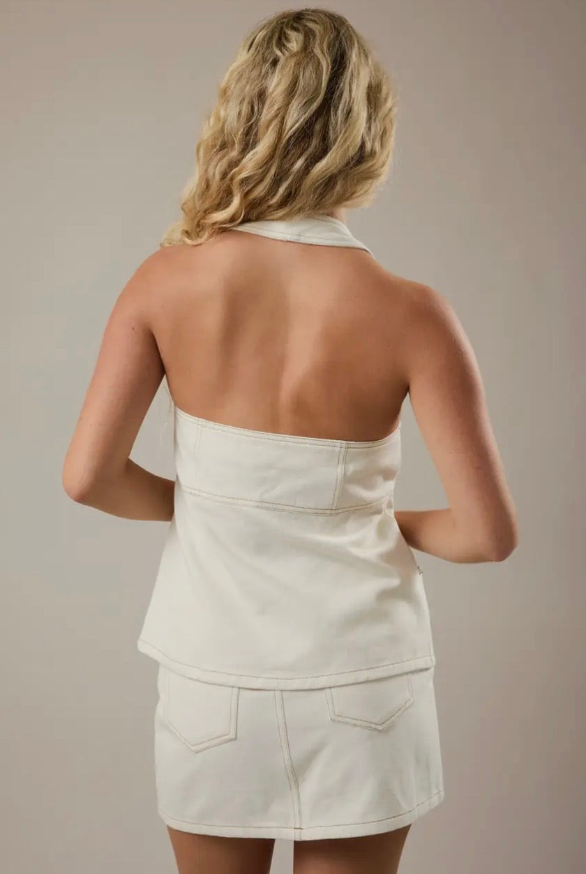 Cream Coast halter top by LE LIS, featuring a stylish sleeveless design with a fitted bodice and tie-neck detail.