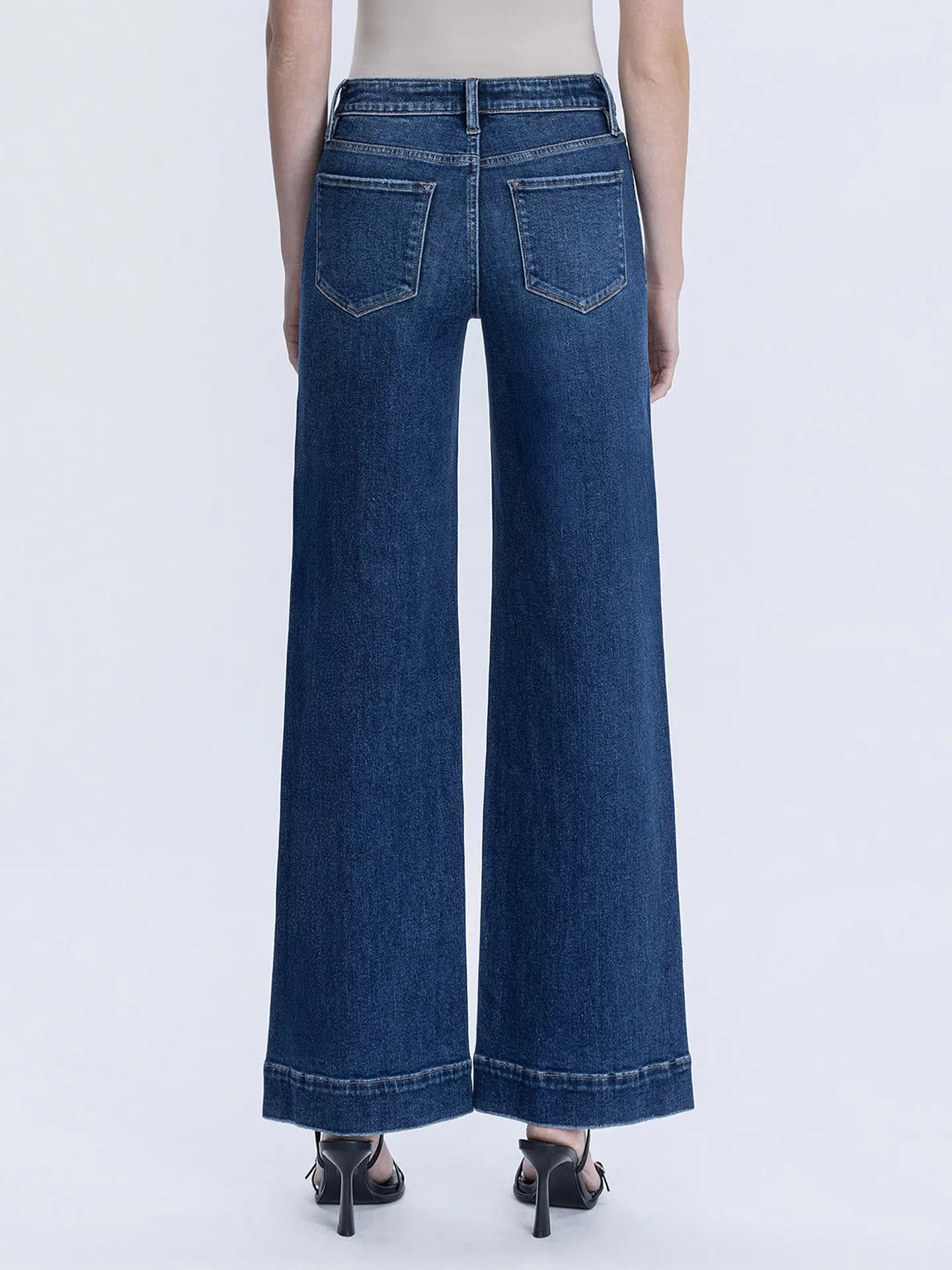 Flying Monkey Harper wide-leg jeans with a high waist and relaxed fit, shown hanging on a wooden rack.