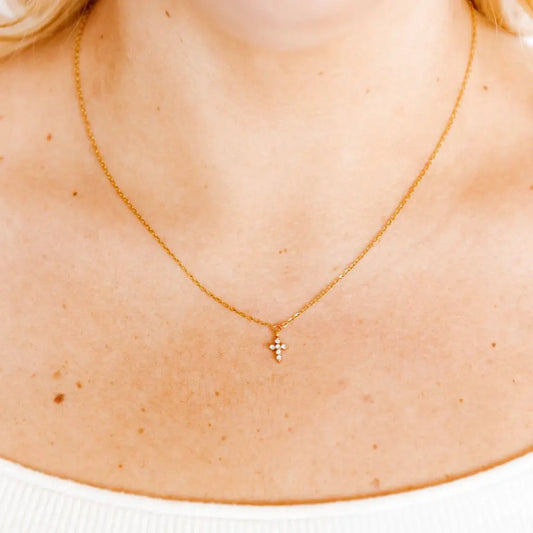 Gold Carly Cross Necklace by Linny Co featuring a delicate cross pendant on a fine chain.